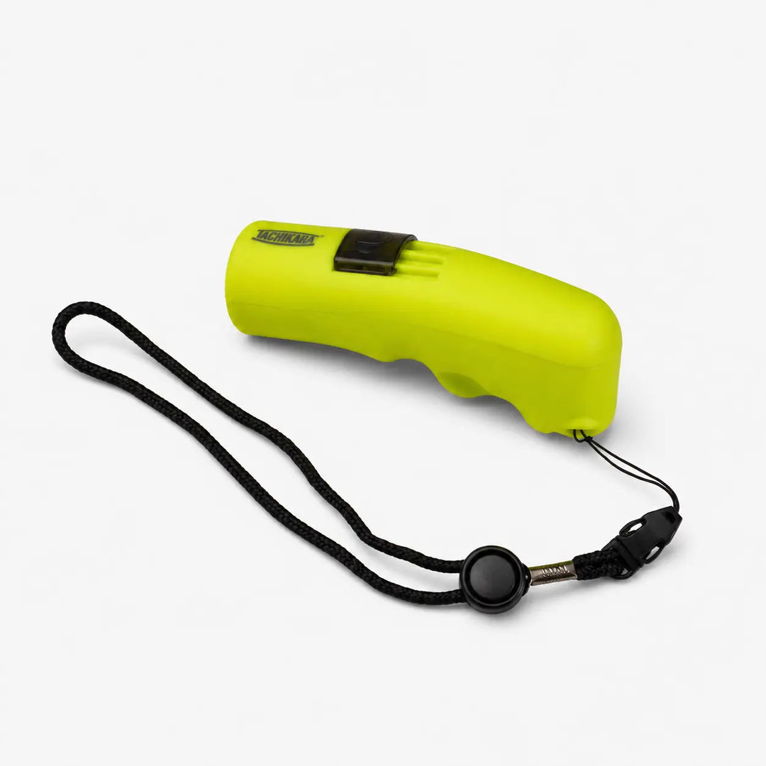 Yellow whistle with black lanyard on a white background